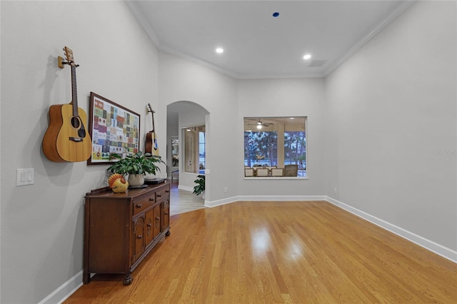 interior space with light wood-type flooring and ornamental molding