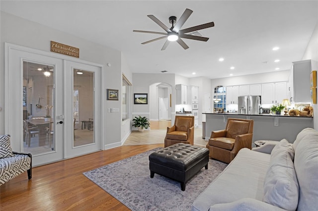 living room featuring ceiling fan and light hardwood / wood-style floors