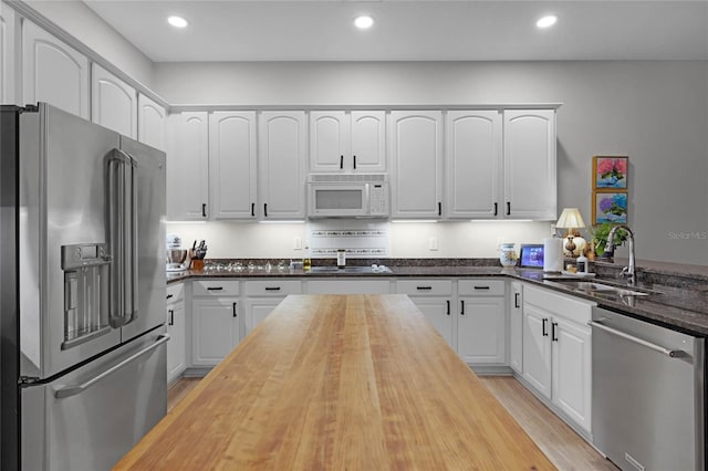 kitchen featuring white cabinetry, sink, and appliances with stainless steel finishes