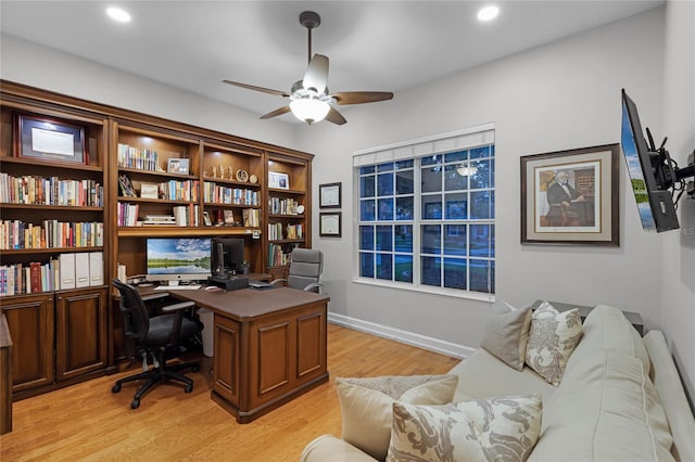 home office with ceiling fan and light hardwood / wood-style flooring