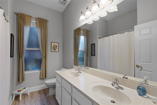 bathroom featuring vanity, hardwood / wood-style flooring, and toilet