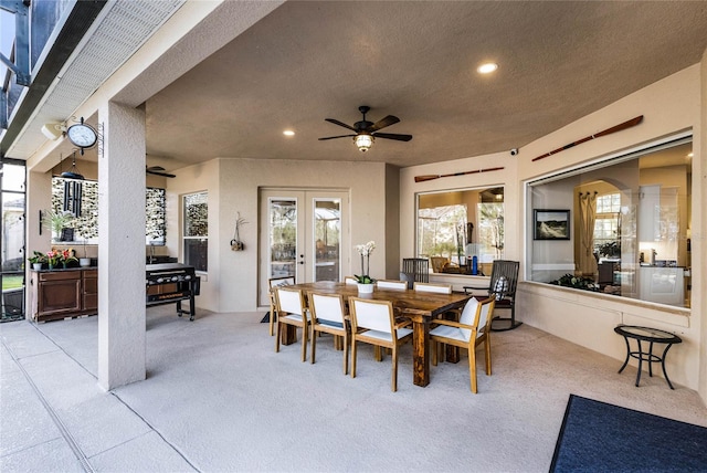 dining space featuring light carpet, french doors, a wealth of natural light, and ceiling fan