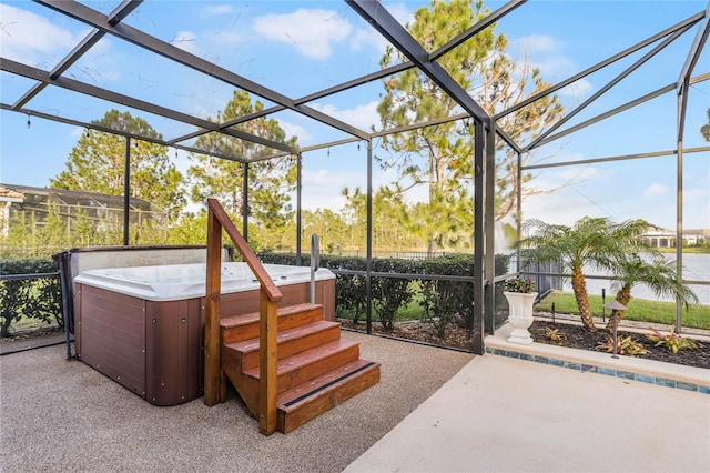 view of patio / terrace with a hot tub and a lanai