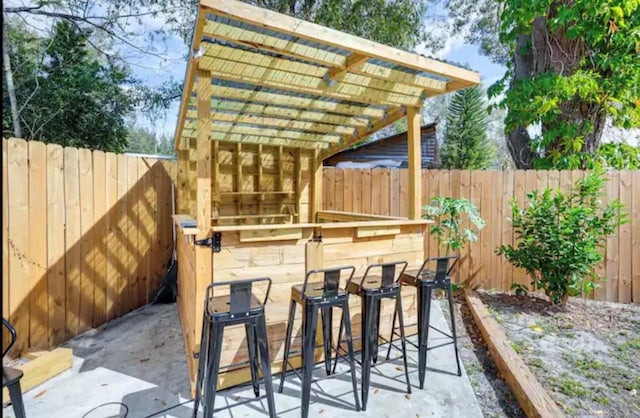 view of patio / terrace with a pergola and a bar