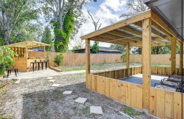 view of yard with a patio area and exterior bar