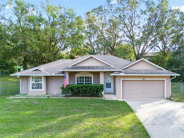 ranch-style home featuring a front lawn and a garage