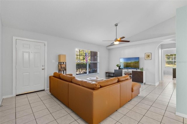 tiled living room with vaulted ceiling, a wealth of natural light, and ceiling fan