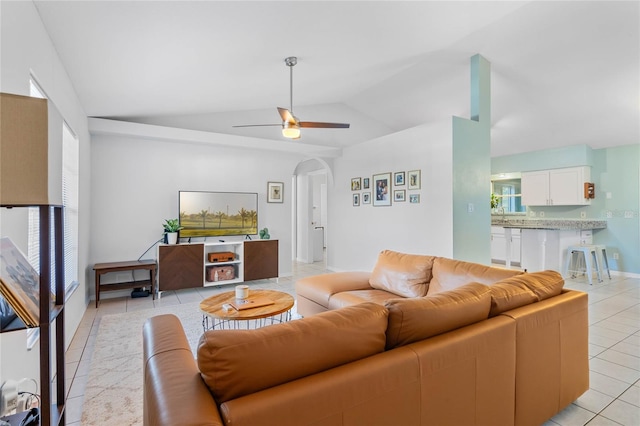 living room with light tile patterned floors, vaulted ceiling, and ceiling fan