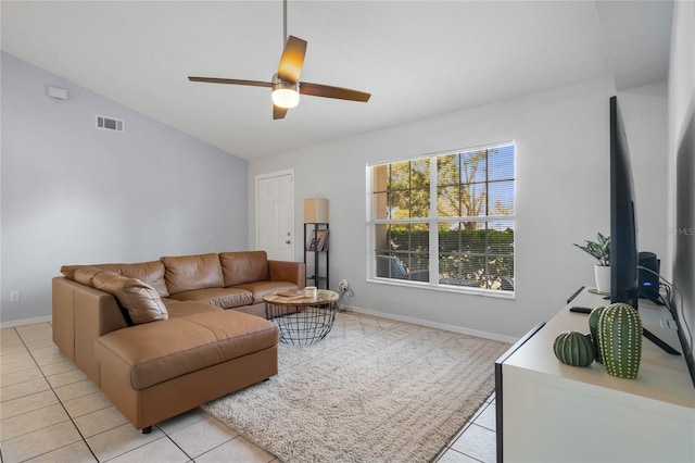 living room featuring ceiling fan, light tile patterned floors, and lofted ceiling