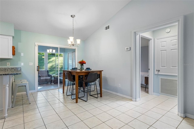 dining room with vaulted ceiling, a notable chandelier, and light tile patterned flooring