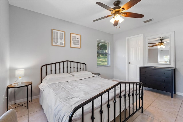 bedroom featuring light tile patterned floors and ceiling fan