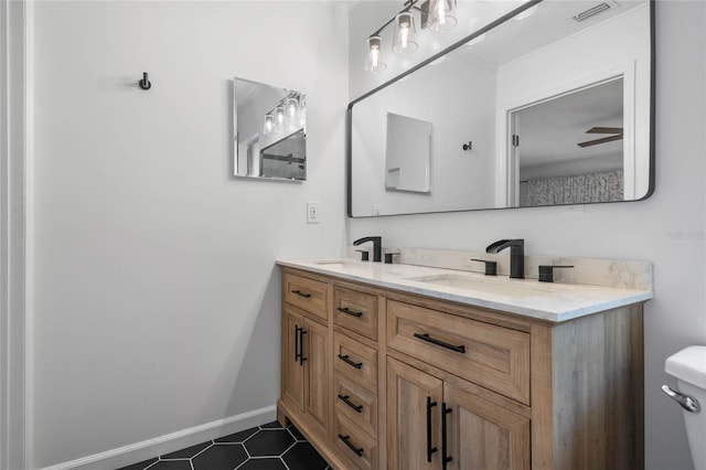 bathroom featuring ceiling fan, vanity, and toilet