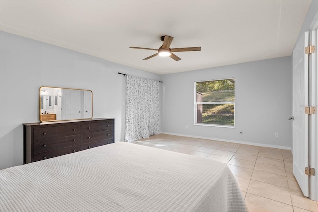 tiled bedroom featuring ceiling fan