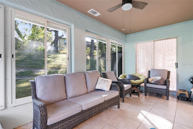 sunroom / solarium featuring ceiling fan