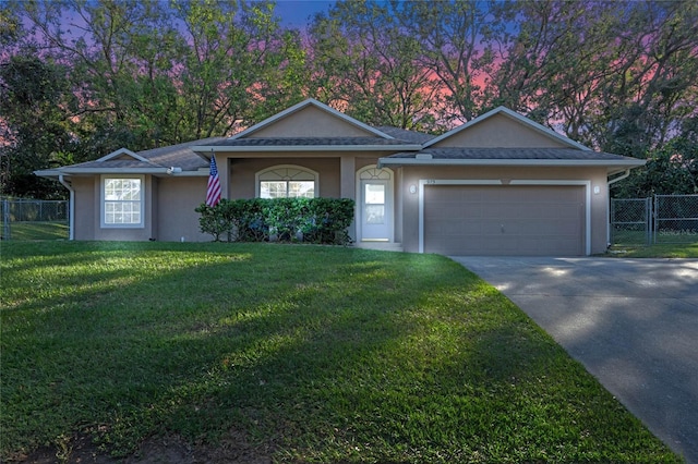 single story home with a lawn and a garage