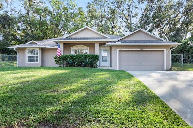 ranch-style house featuring a front lawn and a garage