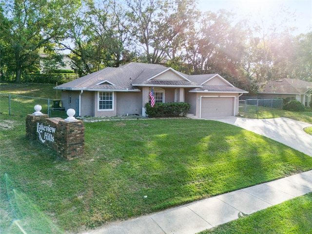 single story home featuring a front lawn and a garage