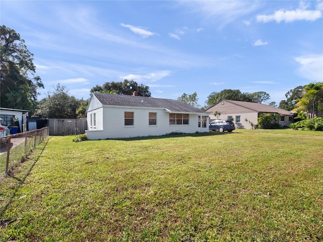 back of house with a yard