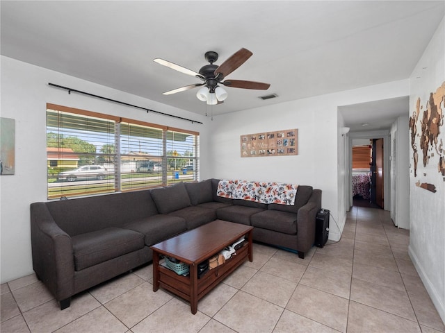 tiled living room with ceiling fan