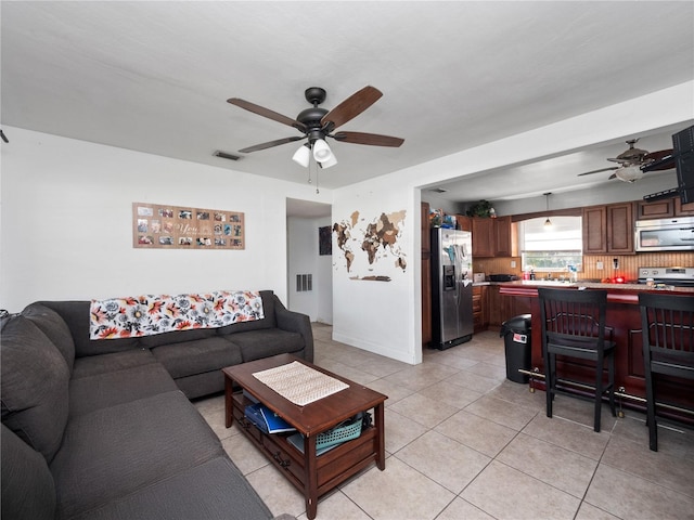 tiled living room with ceiling fan