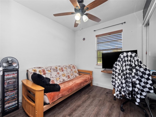 living room featuring ceiling fan and dark wood-type flooring