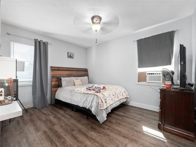 bedroom with dark hardwood / wood-style floors, ceiling fan, and cooling unit