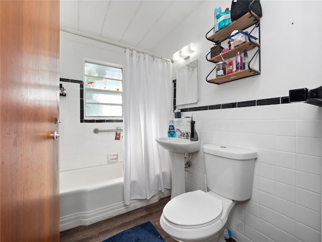 full bathroom with shower / tub combo, sink, tile walls, hardwood / wood-style floors, and toilet