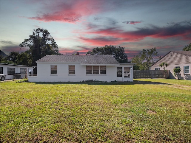 back house at dusk with a yard