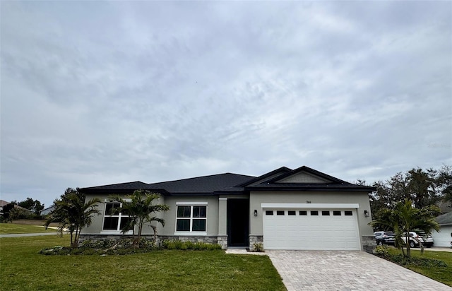 view of front facade with a garage and a front lawn