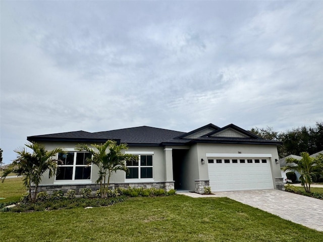 view of front of house with a garage and a front lawn