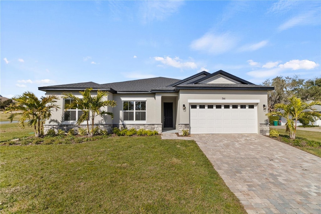 view of front of property featuring a garage and a front lawn