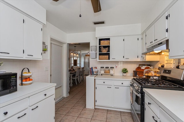 kitchen with backsplash, white cabinets, light tile patterned floors, and stainless steel gas range