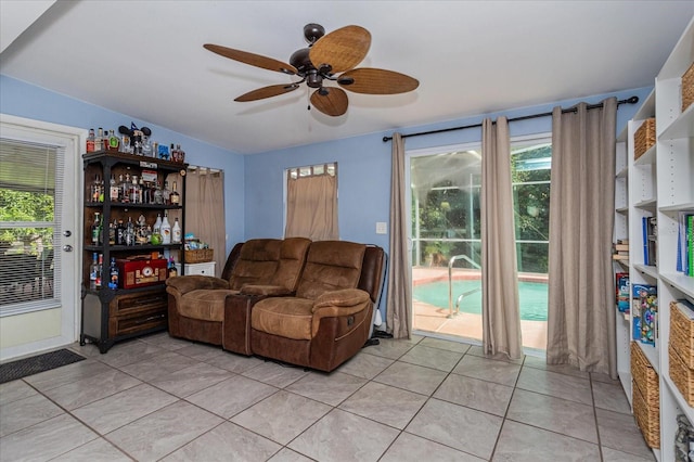 living room with ceiling fan and light tile patterned flooring