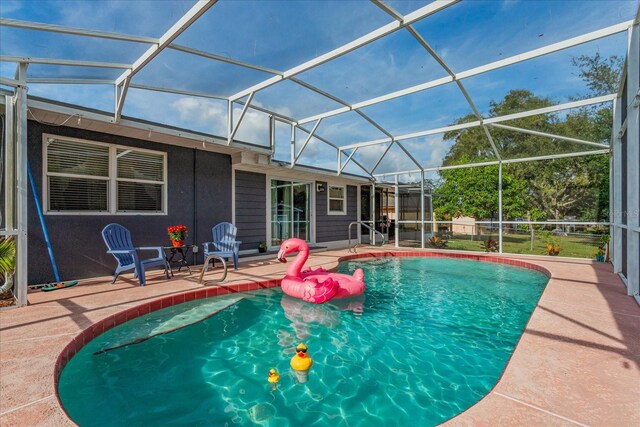 view of pool featuring a patio and glass enclosure