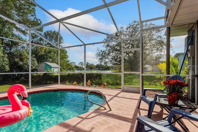 view of swimming pool with glass enclosure and a patio area