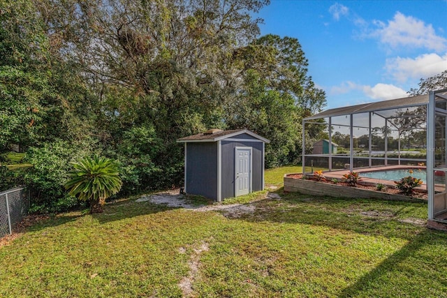 view of yard with a shed and glass enclosure