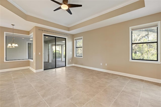 tiled spare room featuring ceiling fan with notable chandelier, plenty of natural light, and crown molding