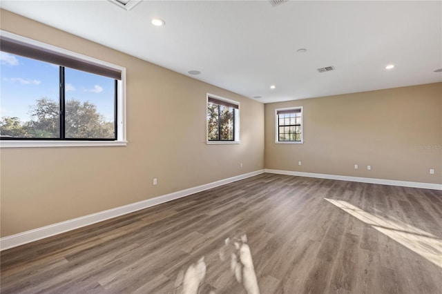 spare room with wood-type flooring