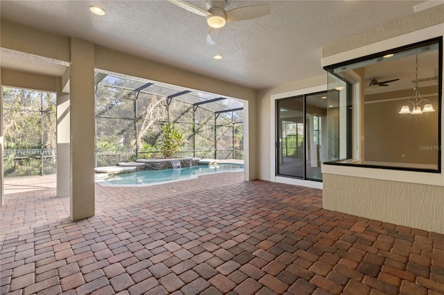 view of swimming pool featuring pool water feature, a patio area, ceiling fan, and a lanai