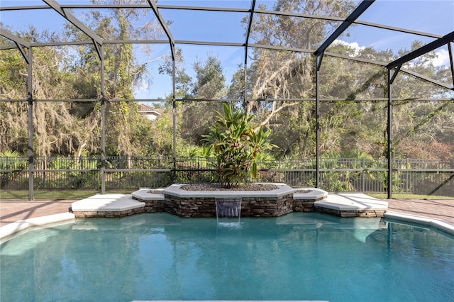 view of swimming pool with pool water feature and glass enclosure