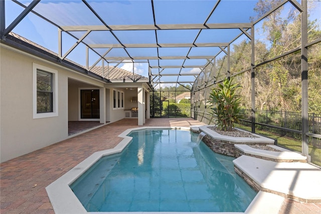 view of pool with pool water feature, a patio area, and a lanai