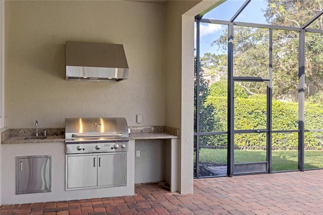 exterior space featuring white cabinetry, wall chimney exhaust hood, and sink