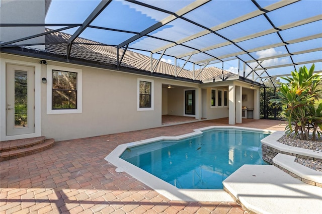 view of pool with a patio area and a lanai