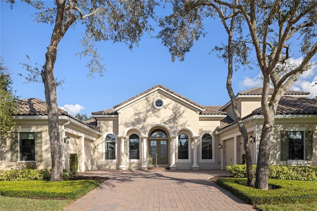 mediterranean / spanish home featuring a garage