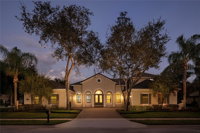 mediterranean / spanish house featuring a yard