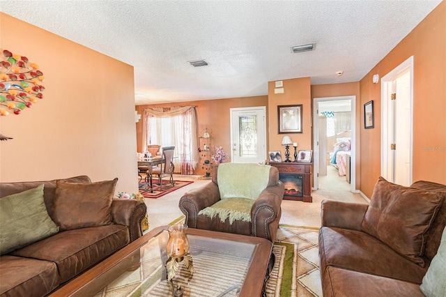 carpeted living room with a textured ceiling