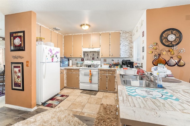 kitchen featuring sink, light tile patterned floors, and white appliances