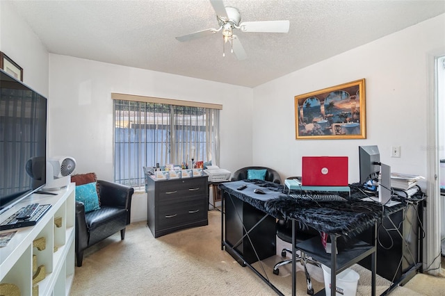 carpeted office with a textured ceiling and ceiling fan