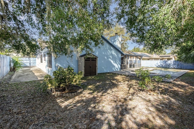 rear view of house featuring a patio area and a swimming pool