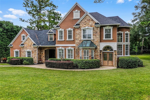 view of front of property with a front yard and french doors